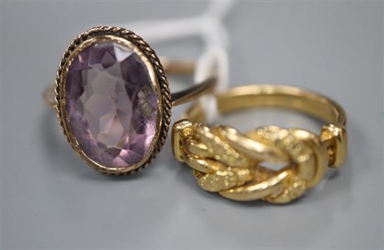 A gold knot ring (marks rubbed but tests as 18ct), 5 grams, and a 9ct gold and amethyst ring, gross 3.2 grams.